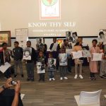OMLI and ASALH mentees hold up photos of prominent African Americans.