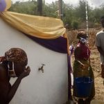 Residents of Akwamufie tasting and gathering fresh clean water from their newly constructed borehole located in the center of their community.