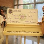 Eta Omega Basileus Maurice Baudy presents Miss Beauford with her first place check